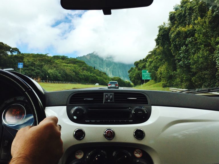 Car dashboard view from inside man driving in Hawaii